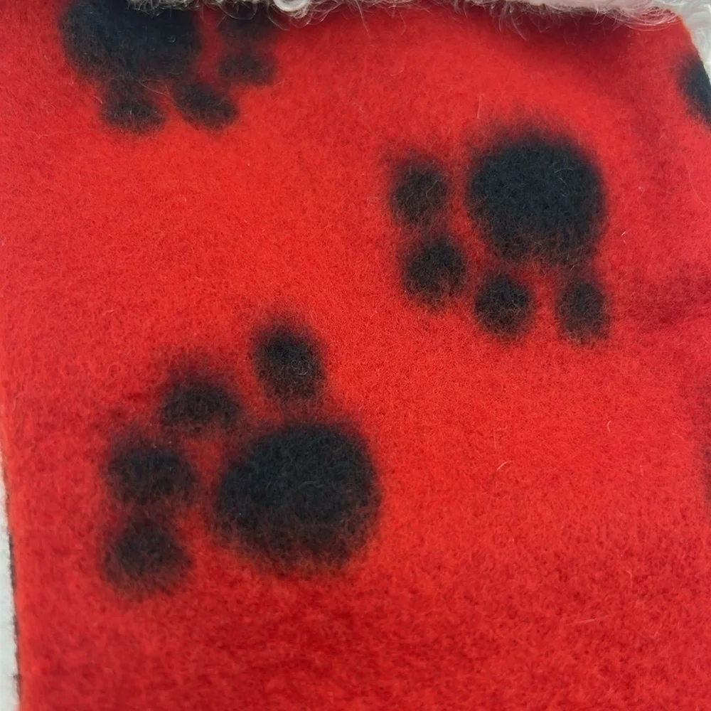 Red Christmas Stocking with Black Paw Prints.